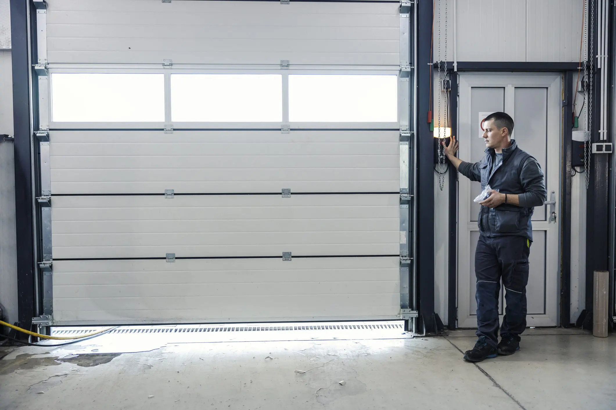 Man operating a large garage door.