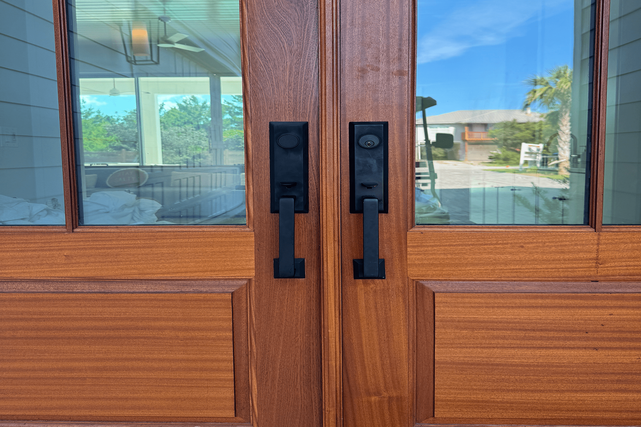 Wooden double doors with glass panels.