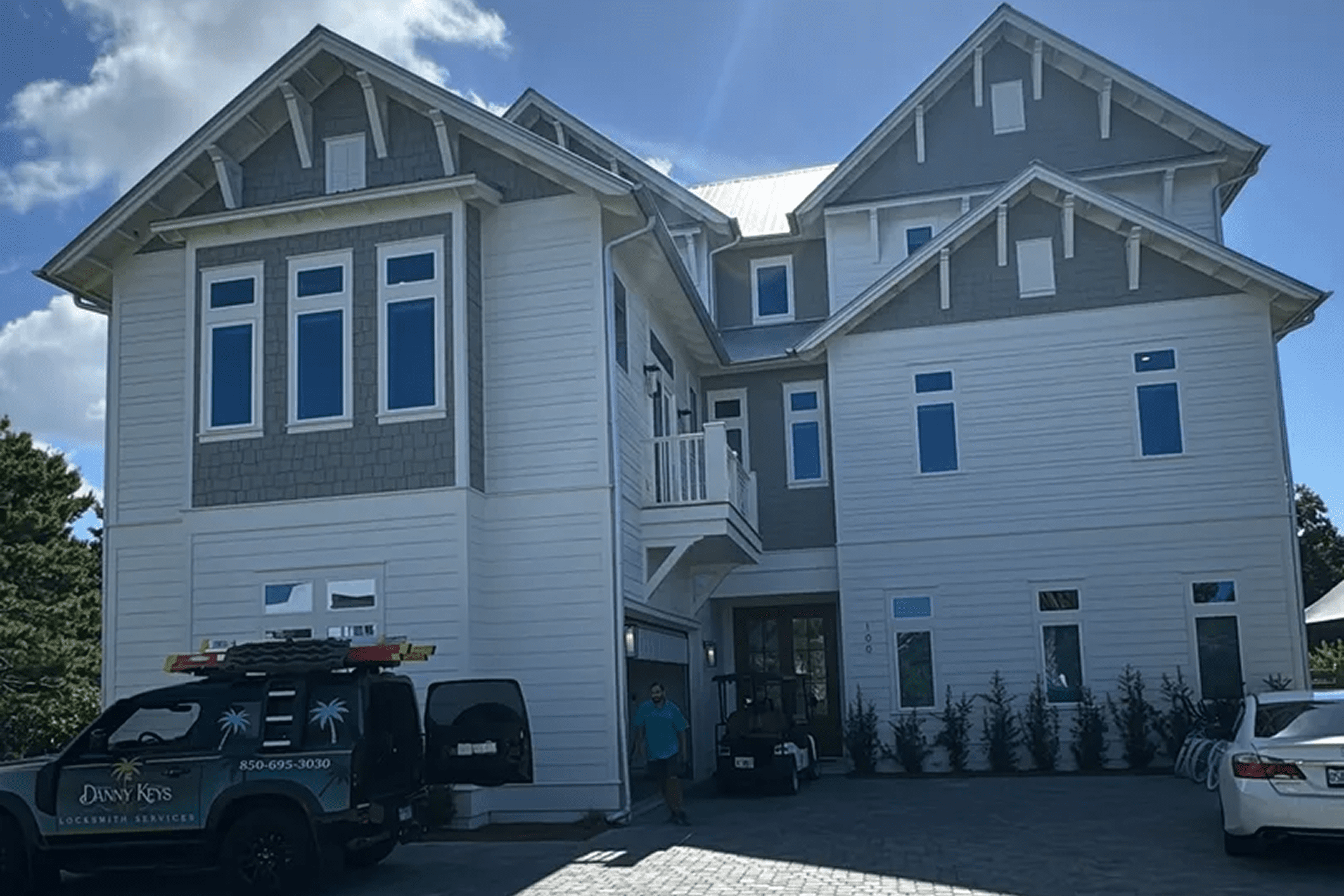 Large house with parked vehicles outside.