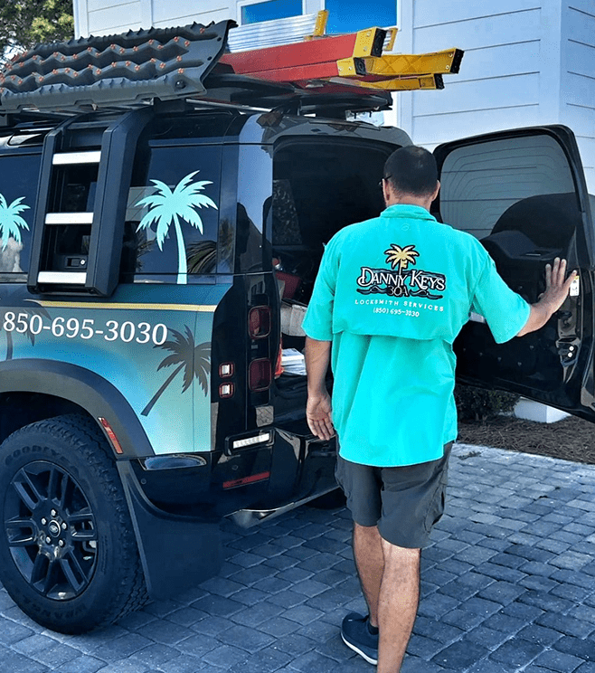 Man opening a black Jeep with tropical logo and phone number.
