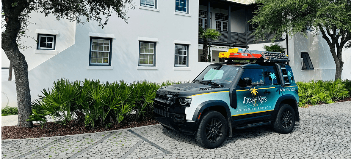 A police vehicle parked near a white building with greenery.